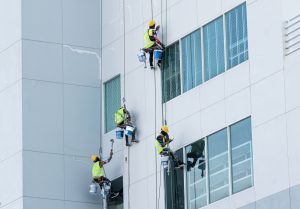 Painter sprinkles paint on the building