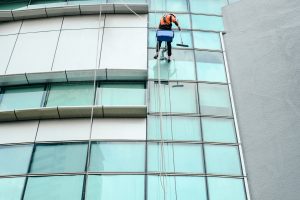 low-angle-view-window-cleaner-cleaning-office-building