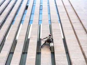 Window cleaner is working on the office building