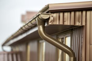 Close-up detail of cottage house corner with metal planks siding