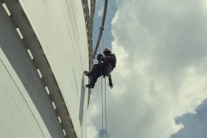 Male worker rope access height safety inspection of thickness st