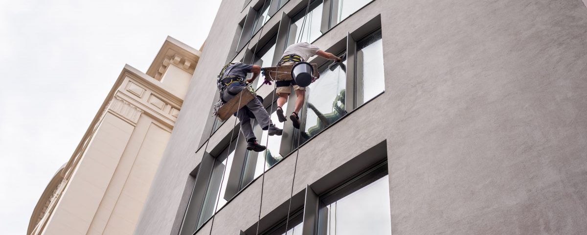two-workers-washing-windows-outside-building (2)