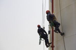 Male two worker rope access height safety inspection of thicknes