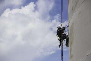 Male worker down height tank roof rope access safety inspection
