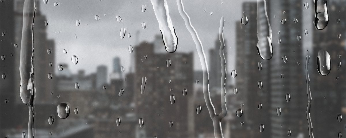 City view through window with rain drops