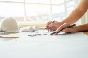 Hands of Engineer working on blueprint,Construction concept. Eng