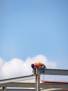Builder welding on high-rise steel frame